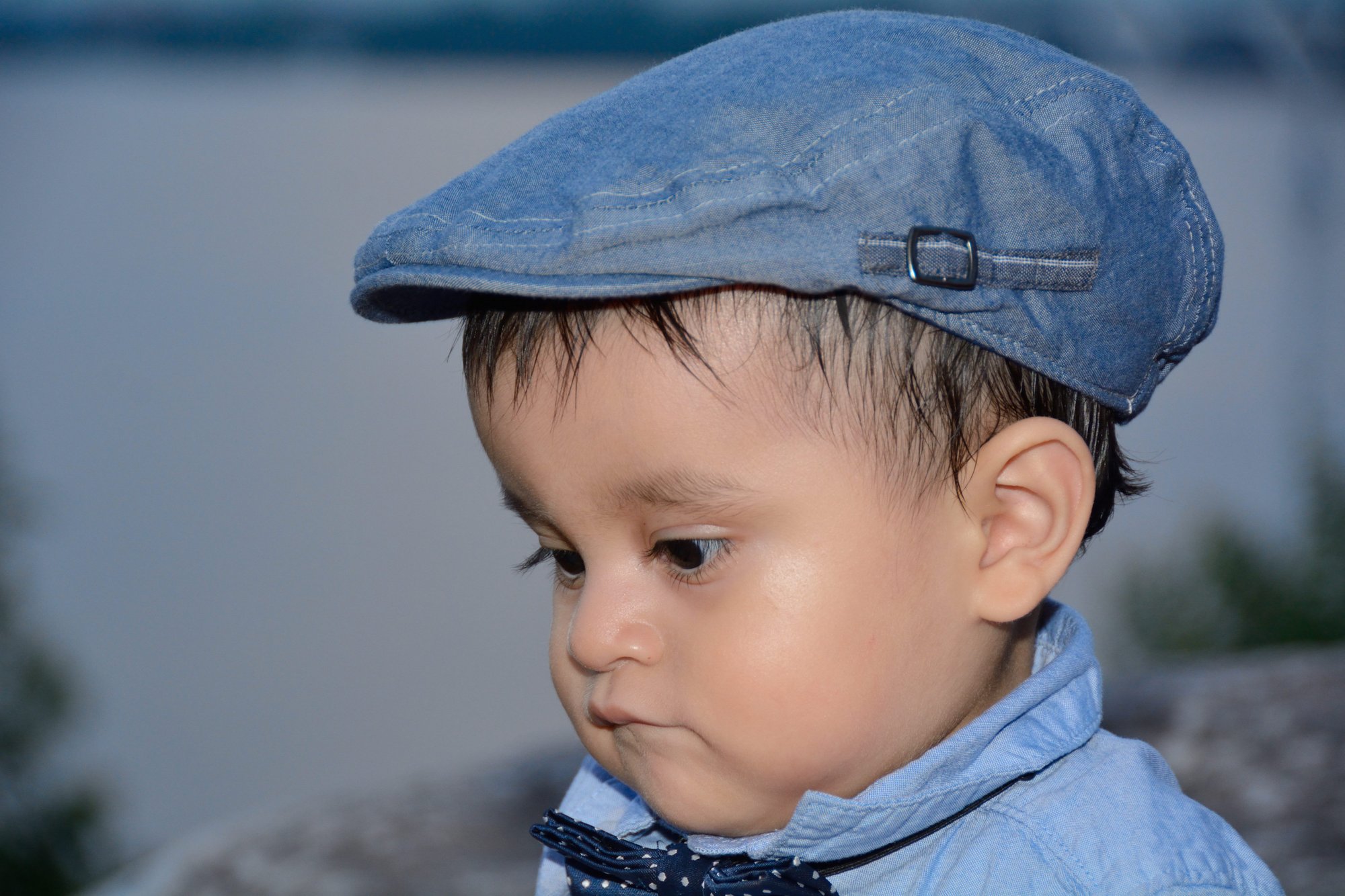 tomas hric photography stunning family photographer portrait of handsome little boy with blue hat national harbor md