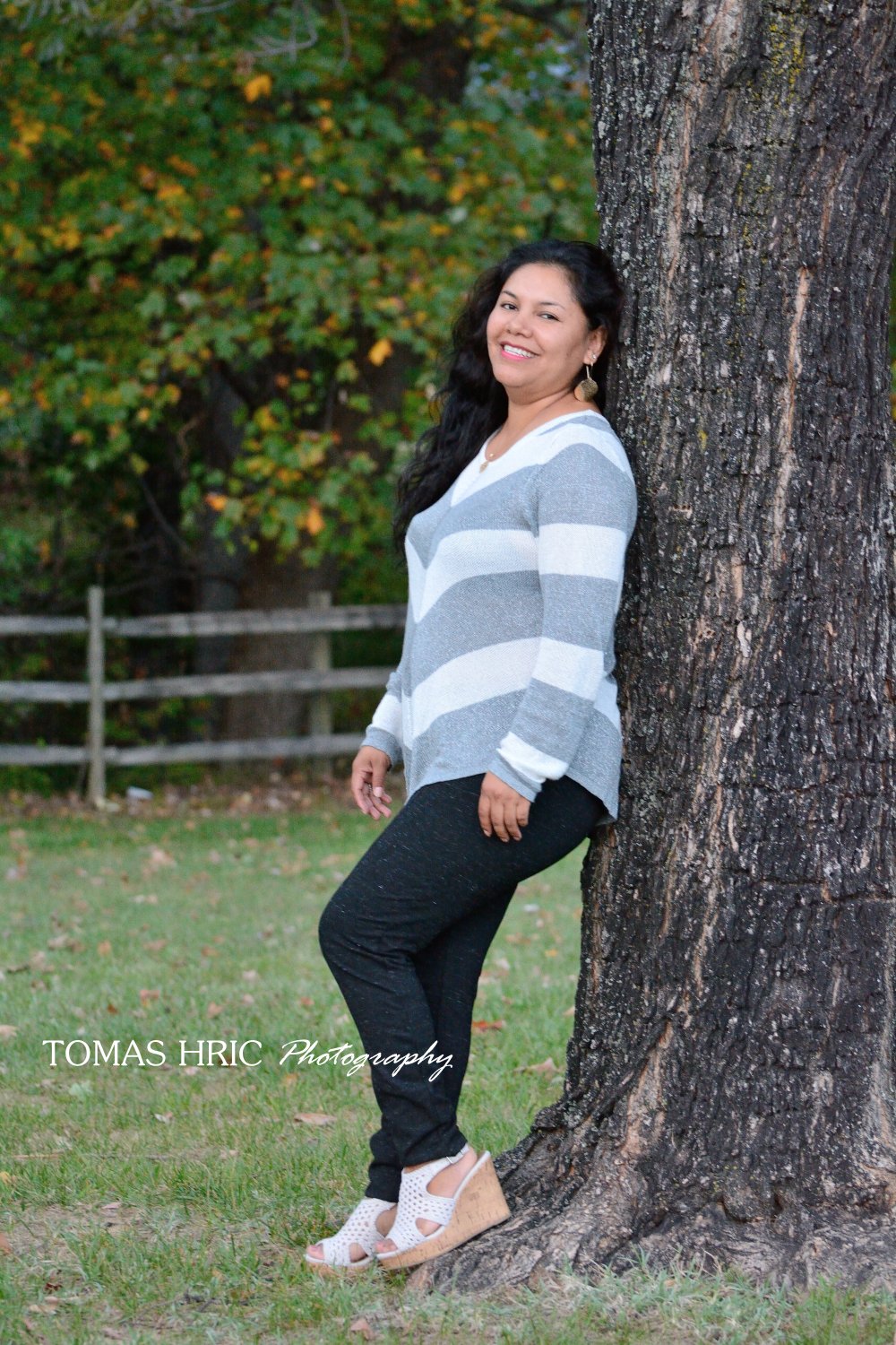 Best family photographer in Northern Virginia Woman posing next to tree
