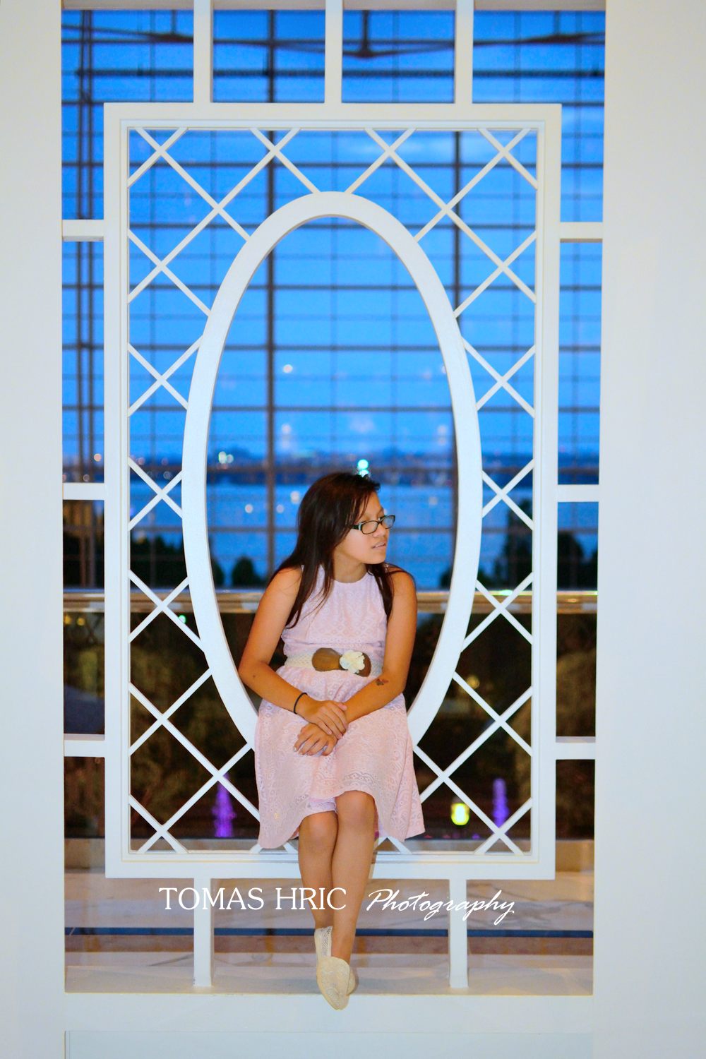 portrait of a girl in pink dress with glasses at the gazebo at national harbor md