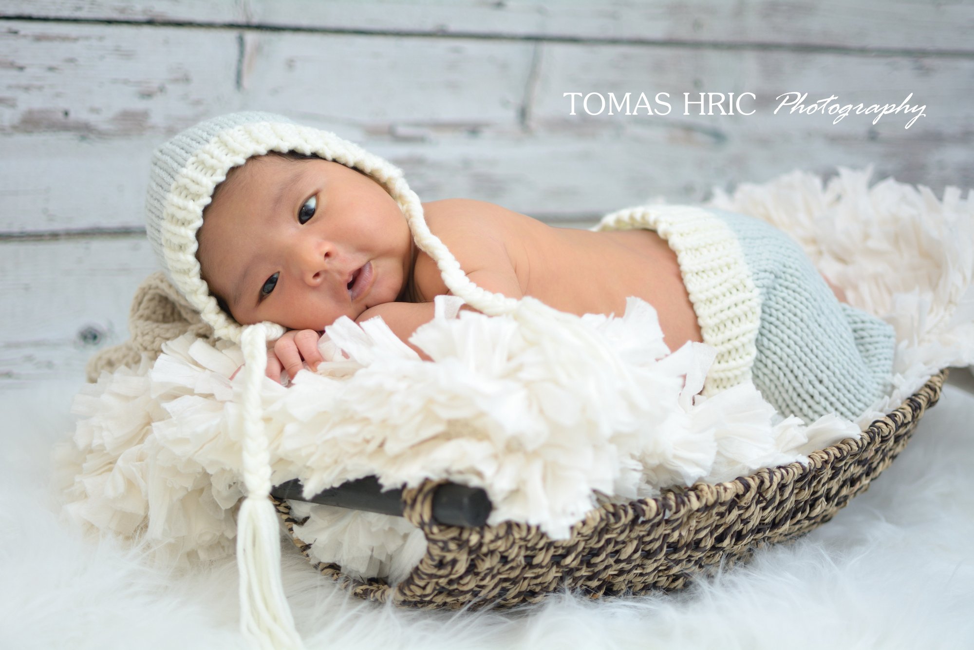 newborn picture of baby in a basket looking at camera in northern virginia